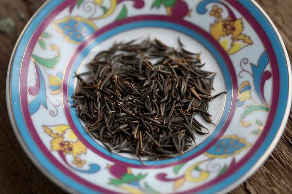 black cosmos seeds on a colourful plate