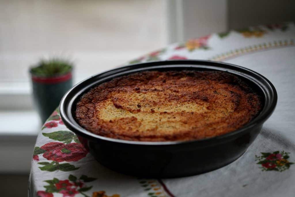 cooked cassava pie on a floral tablecloth