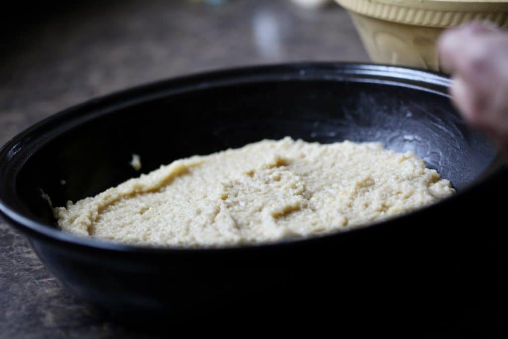 layer of cassava in a black baking dish