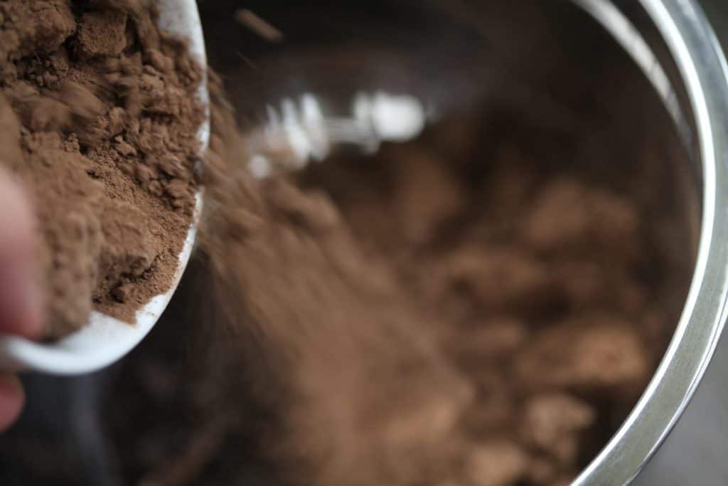 brown clay being poured into a bowl