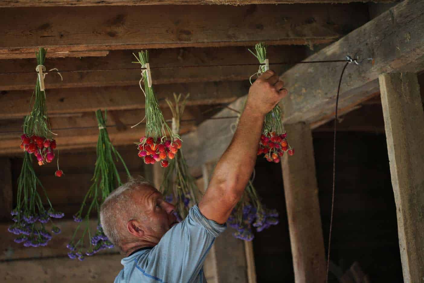 attaching flowers to a hanging line