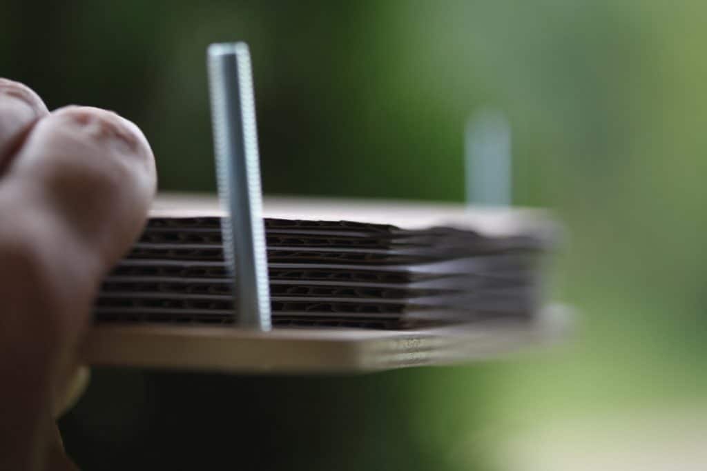 a hand holding a side view of a flower press