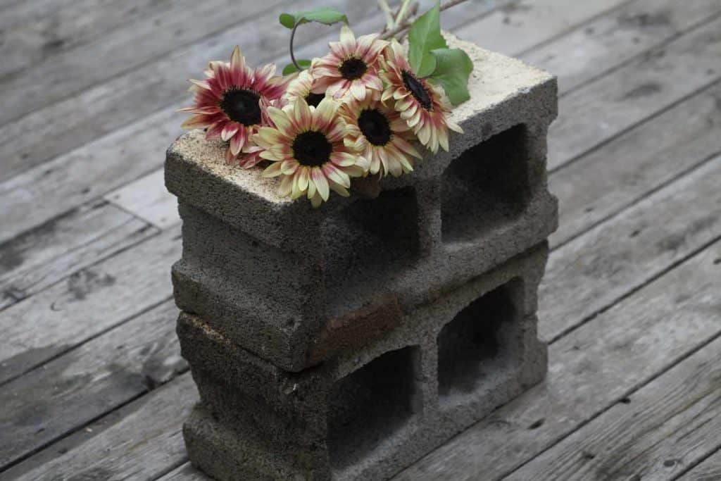 two cement bricks topped with sunflowers