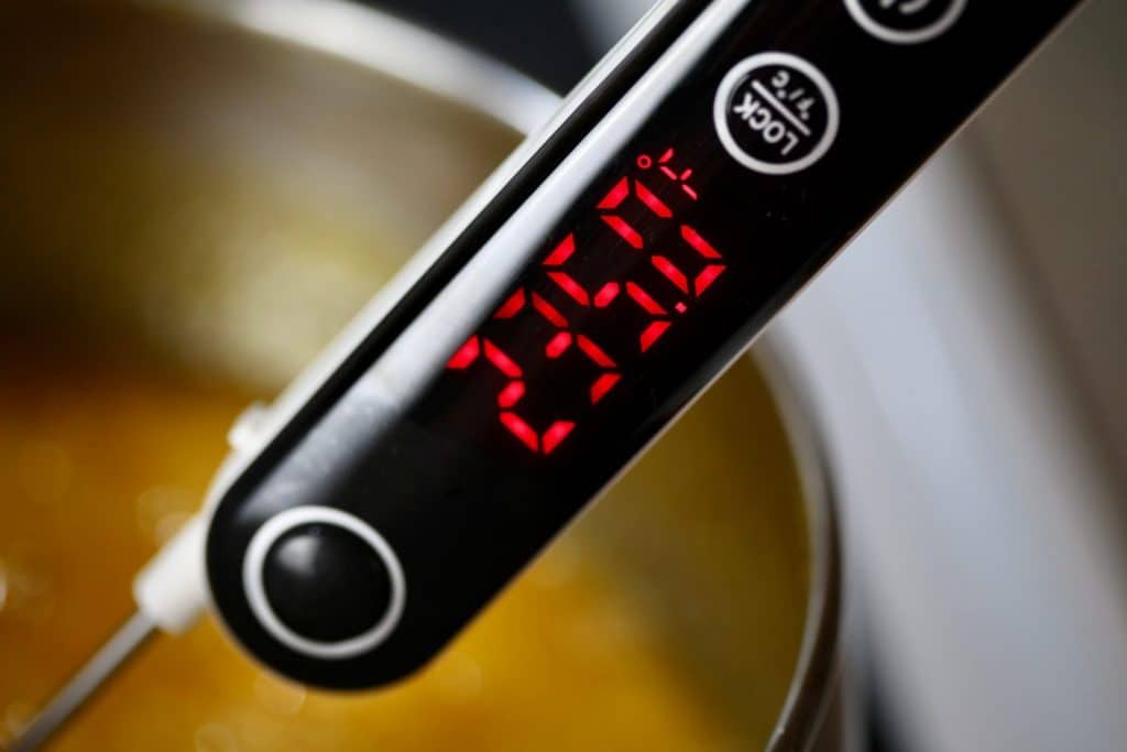 candy thermometer reaching 235°F