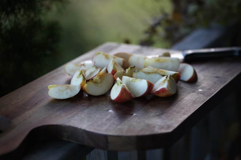 chopped apples on a wooden cutting board