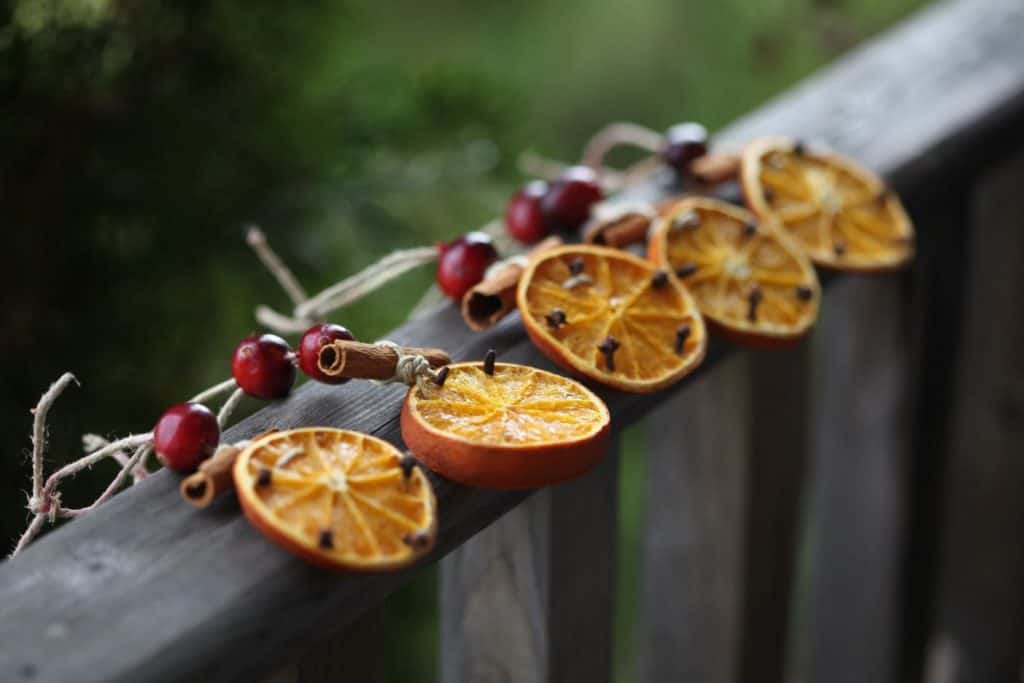 dried orange slice ornaments on a wooden railing