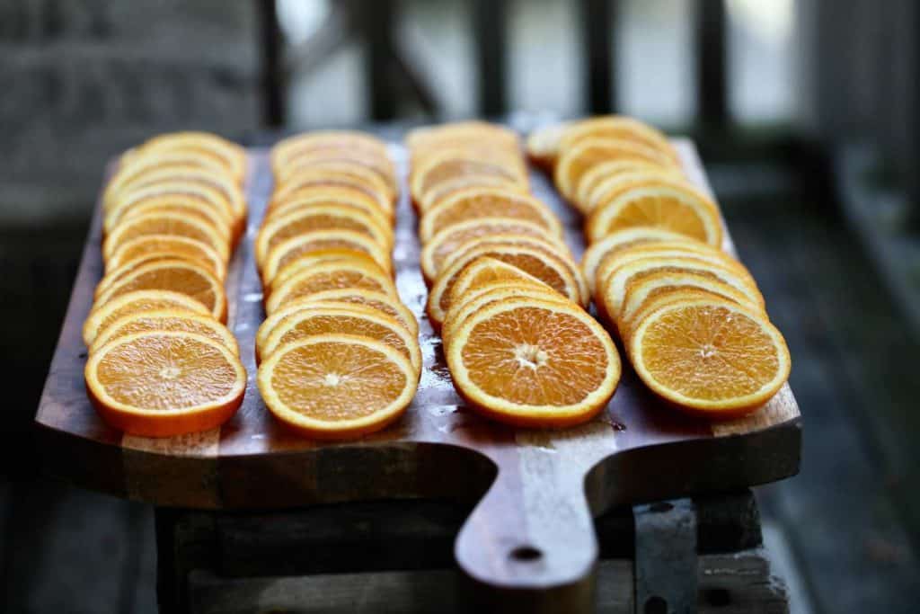 freshly made orange slices on a wooden cutting board