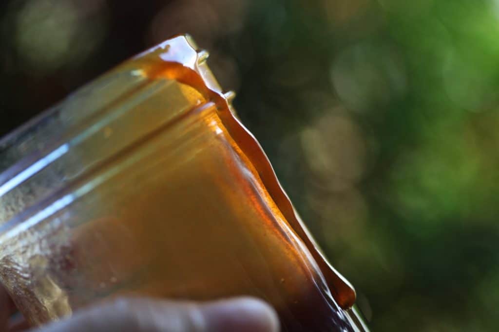 a mason jar covered with amber coloured apple cider syrup