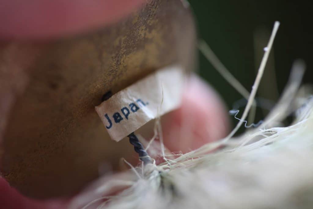 a vintage tag on a bottle brush tree base