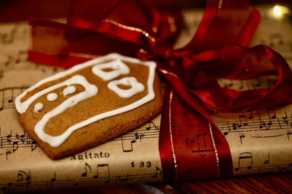 a gift decorated with a little gingerbread house cookie