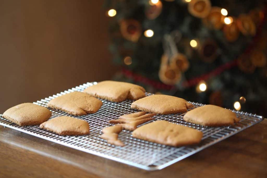 freshly baked gingerbread house cookies on a cooling rack