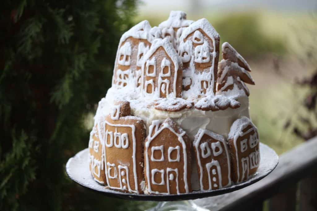 gingerbread cake with cookie village dusted with icing sugar  snow