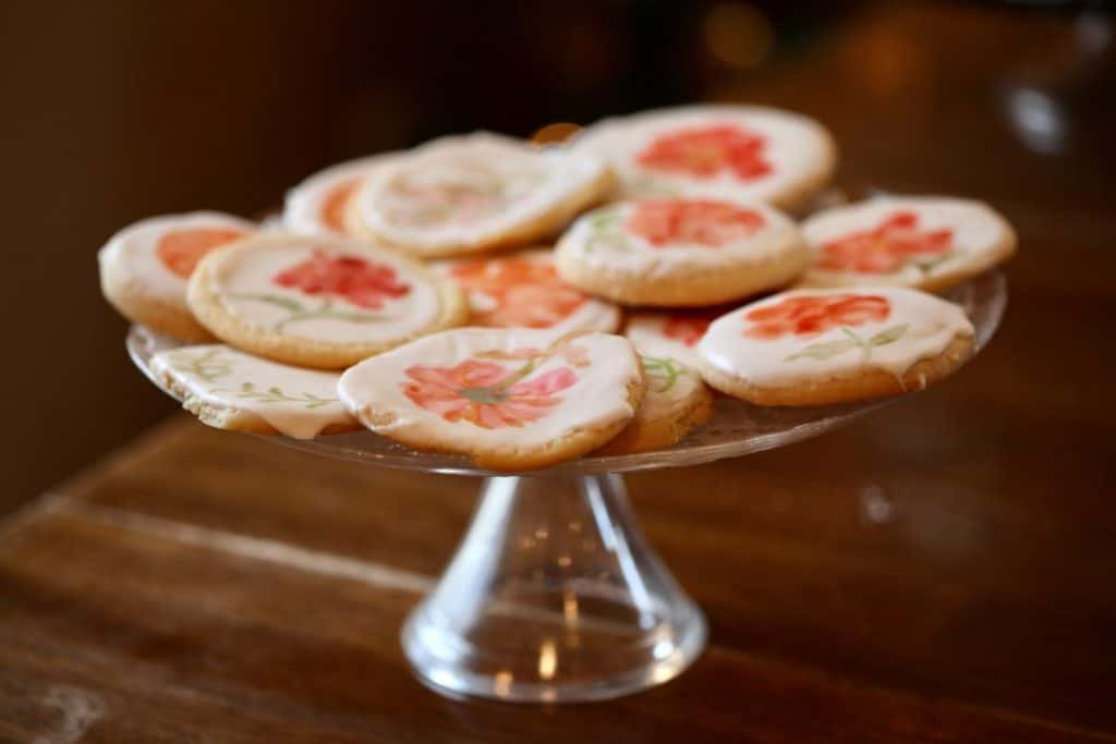 how to make watercolor sugar cookies- a platter with cookies painted with different flower designs