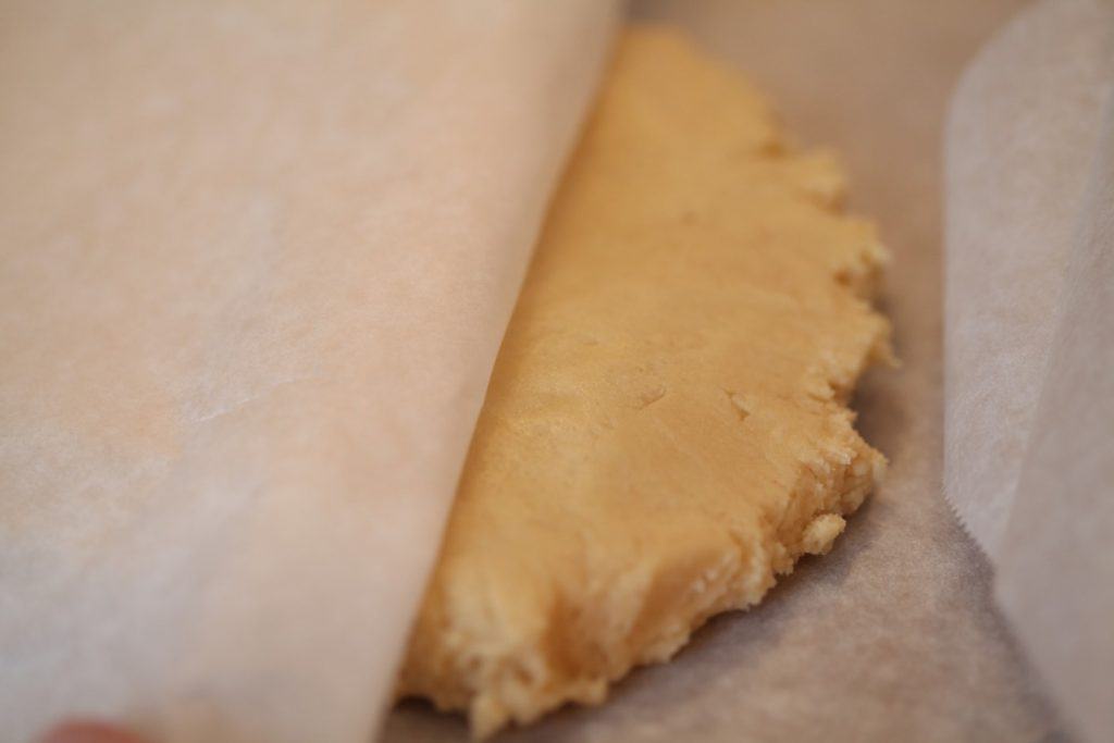 sugar cookie dough between parchment