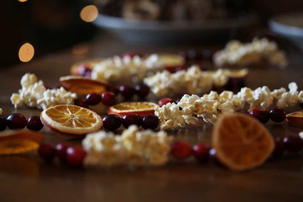 cranberry, orange and popcorn garland on a table