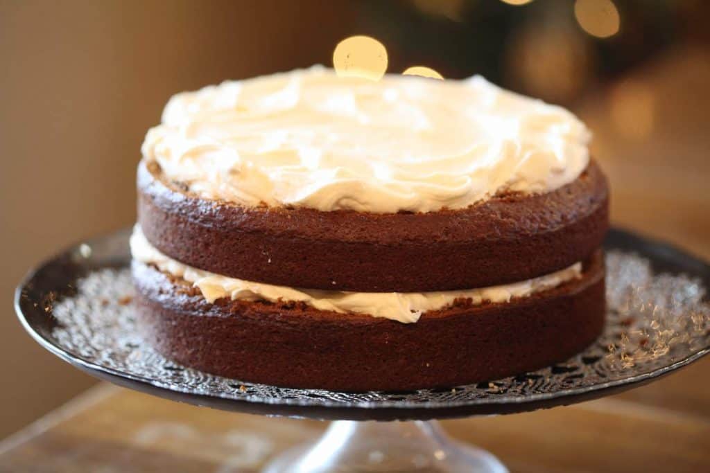 the second layer of gingerbread cake topped with cream cheese frosting