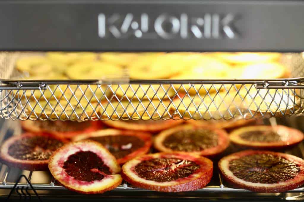 an air fryer dehydrating several shelves of fruit