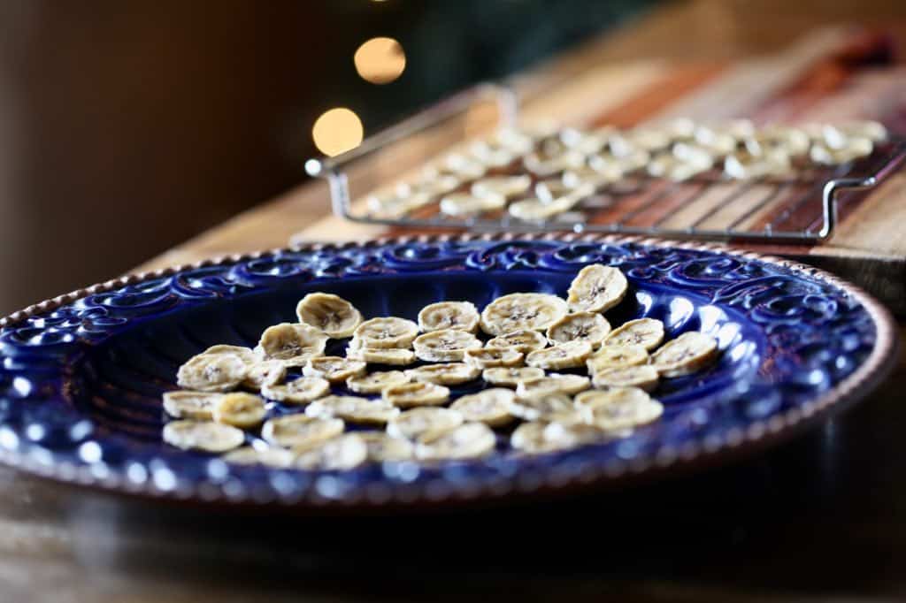 dehydrated banana chips on a blue platter