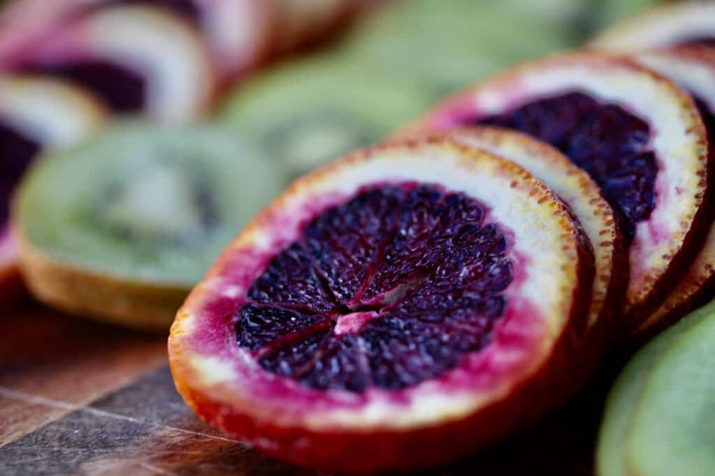 slices of kiwi and blood oranges waiting to be dehydrated in the air fryer