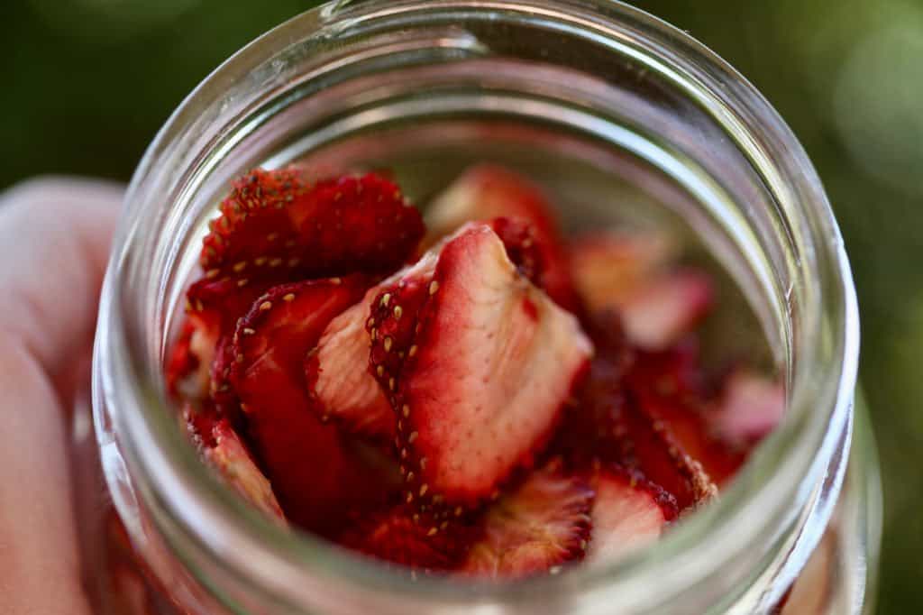 a mason jar with dried strawberries