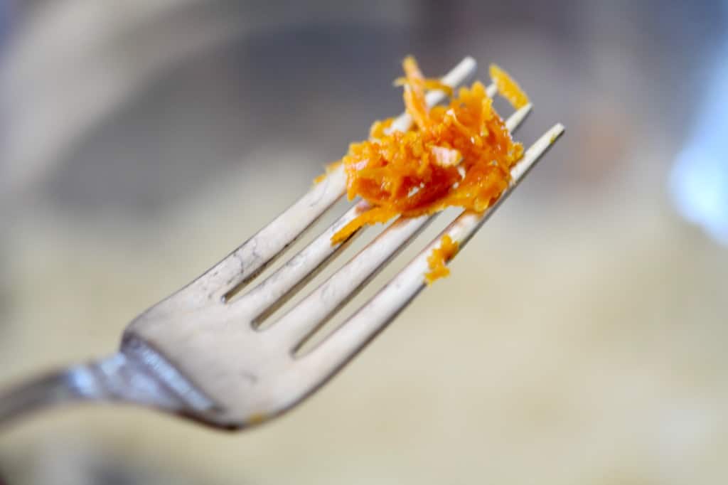 grated orange zest on a silver fork