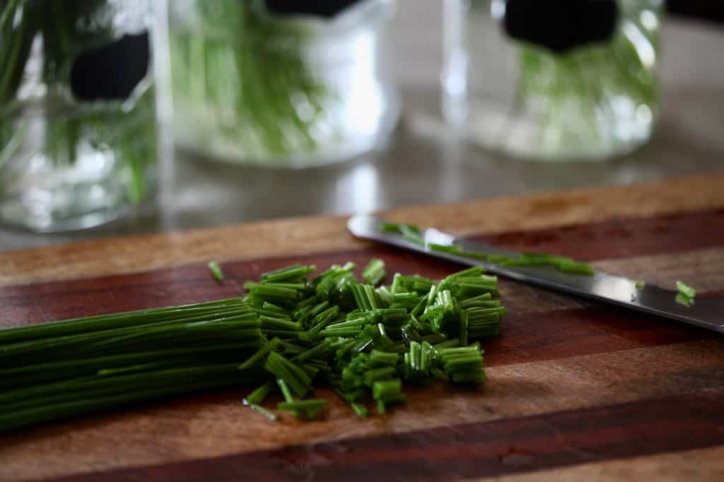 chopped chives on a cutting board
