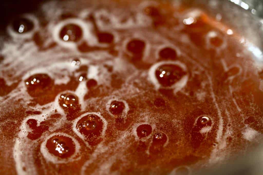 rose hip syrup simmering in a pot