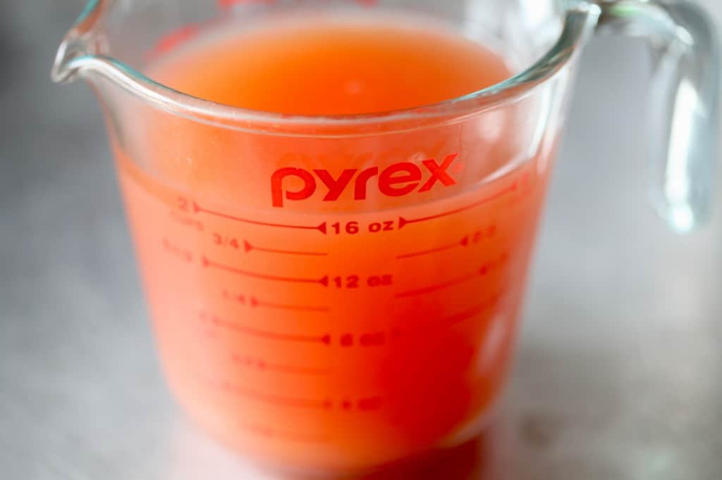 a measuring cup with 2 cups of rose hip infusion