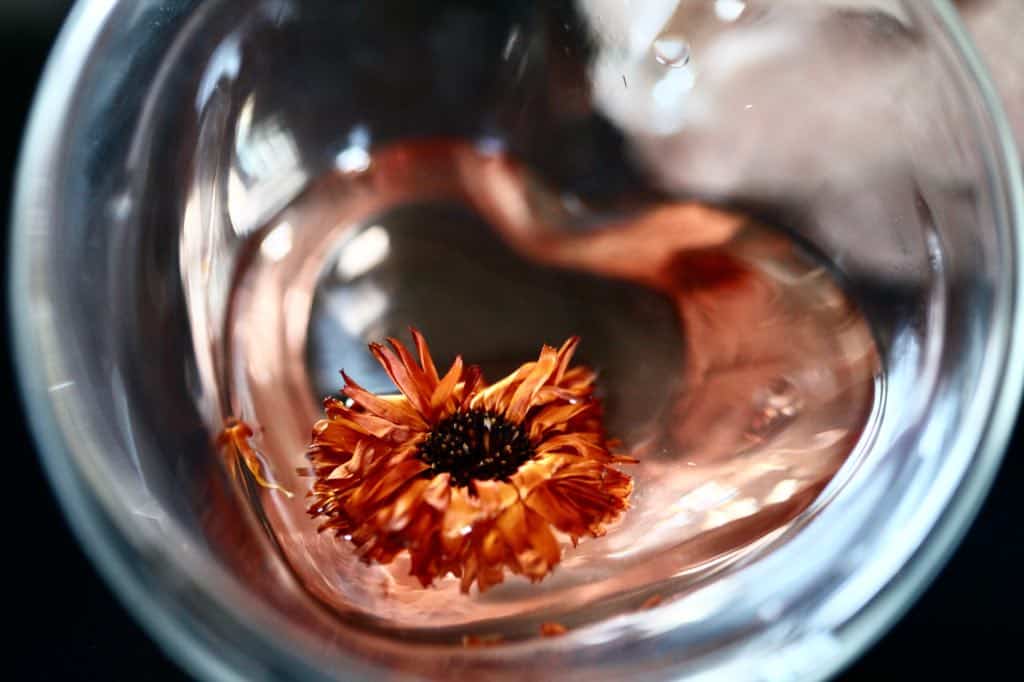 calendula tea with a floating dried calendula flower