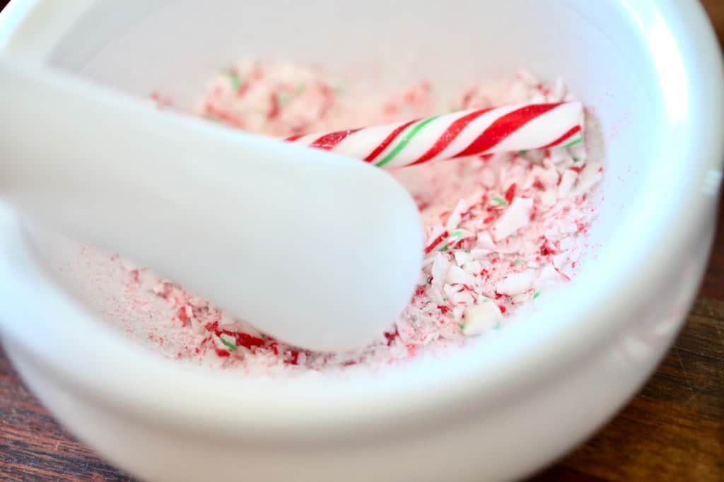 crushing candy canes with a mortar and pestle