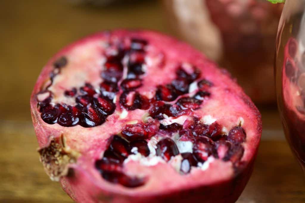 a pomegranate fruit cut in half