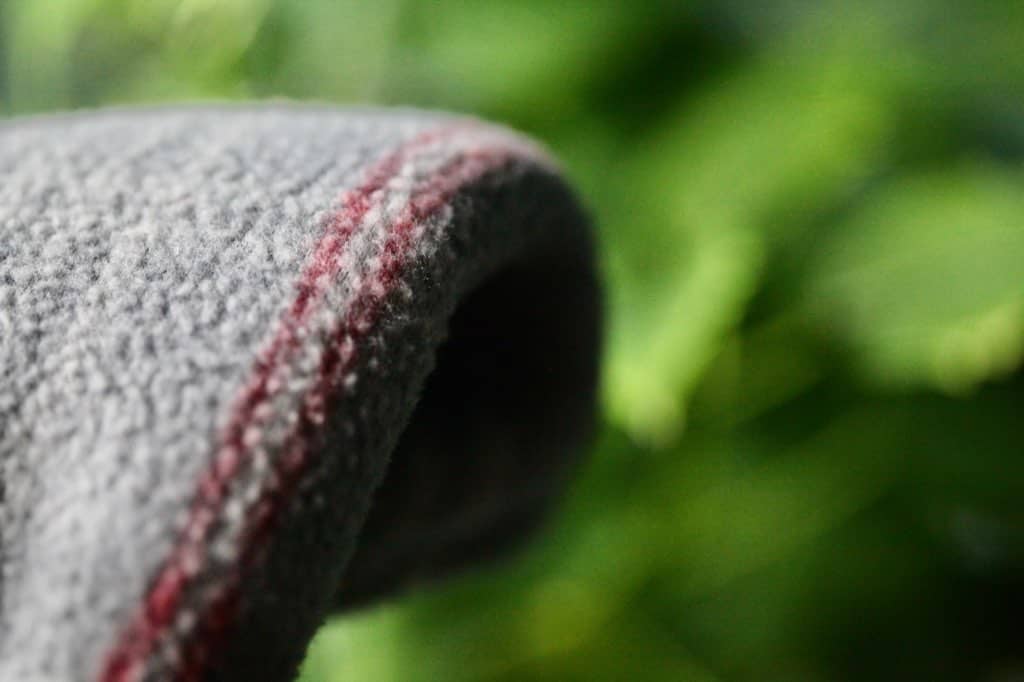 a grey blanket in front of a green poinsettia