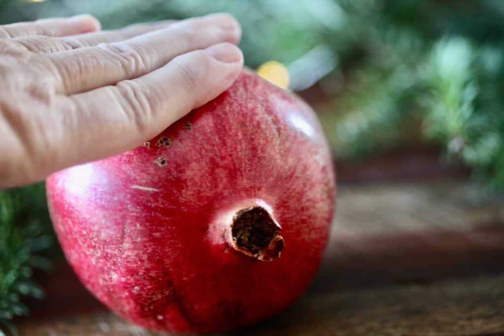 roll the pomegranate against a hard surface