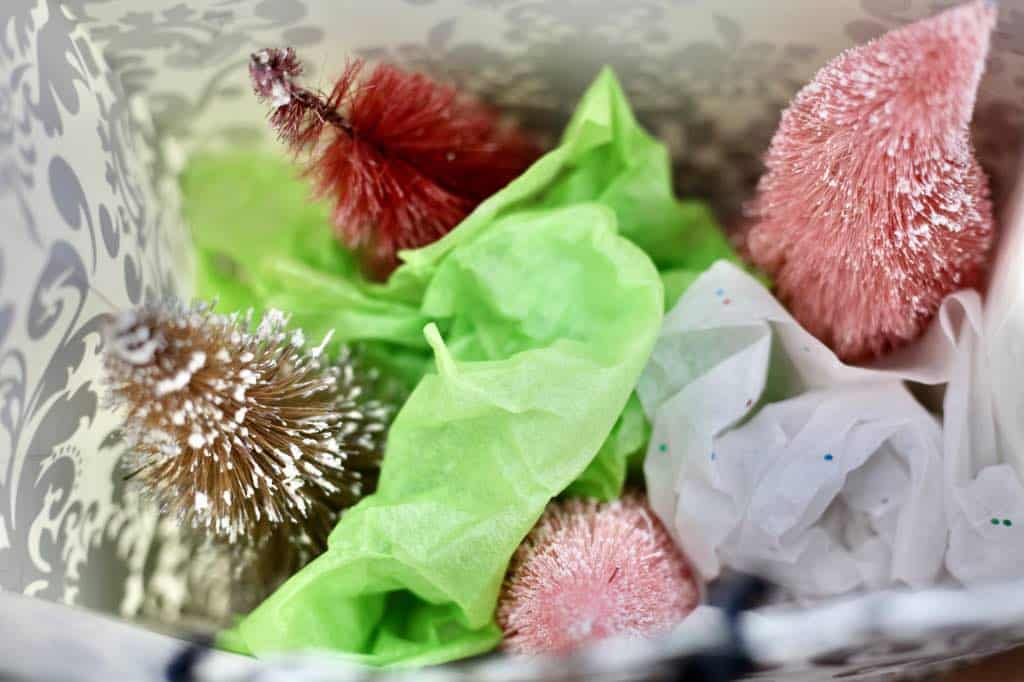 larger bottle brush trees stored in a high sided bag, with tissue paper wedged for support