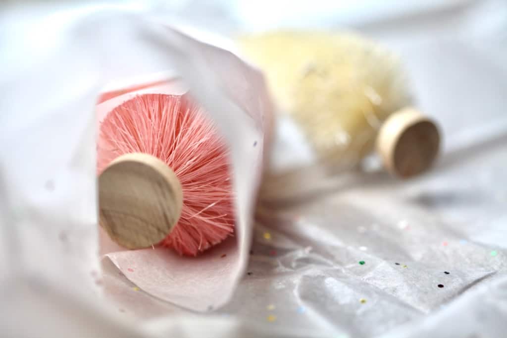 ornamental christmas tree decorations being wrapped in tissue paper