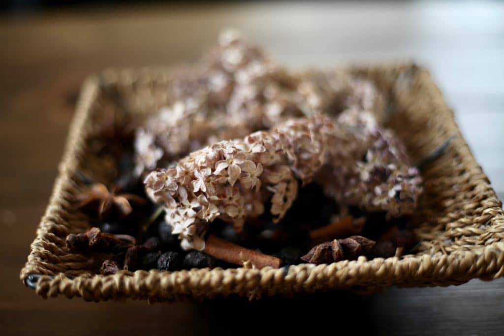 dried lilacs added to potpourri in a basket, another way to use dry lilacs