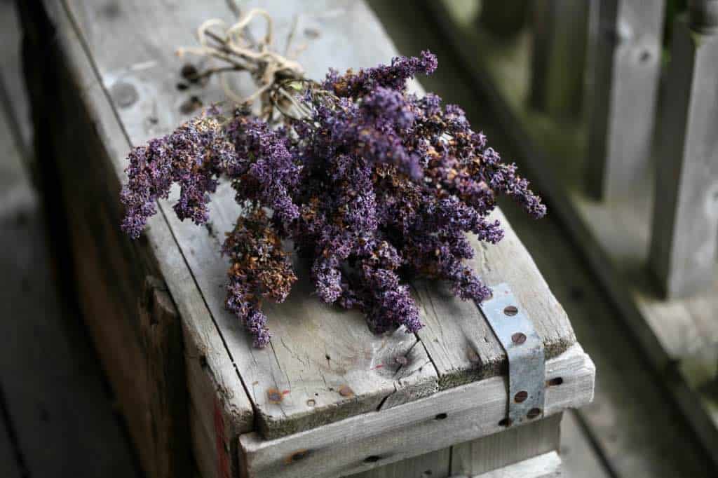 a dried lilac bouquet on an old wooden box