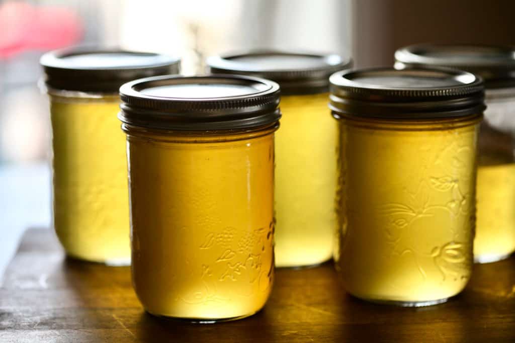 yellow dandelion jelly in mason jars