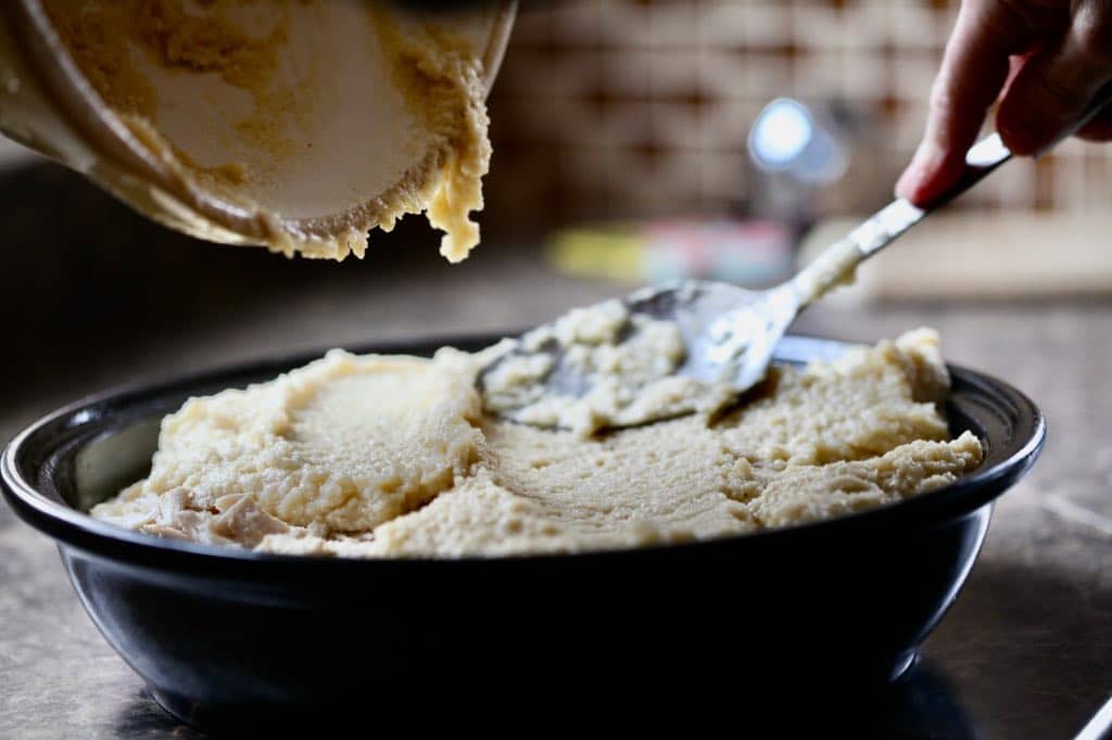 filling a cooking dish with a batter