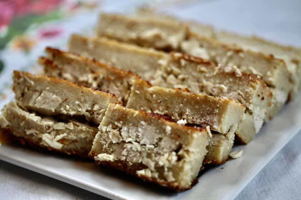 pieces of cassava pie sliced up on a plate